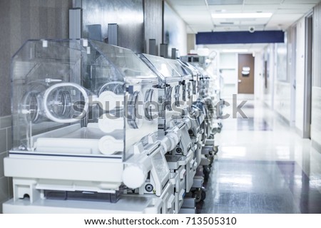 Newborn infant incubator boxes in a hospital corridor Royalty-Free Stock Photo #713505310