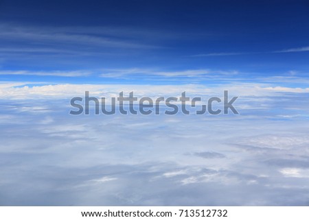 White clouds floating above ocean. Blue water.
