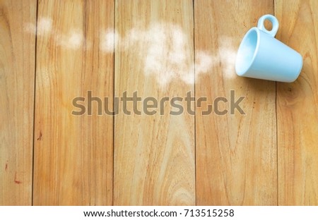 coffee cup and smoke on wood board background. using wallpaper or background for education, business photo. Take note of the product for book with paper and concept or copy space and note.