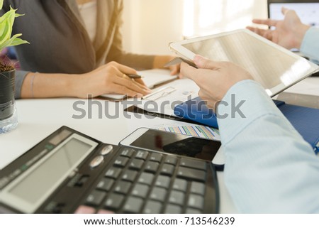 Investor executive discussing plan financial graph data on office table with laptop and tablet, finance, accounting, investment, meeting.