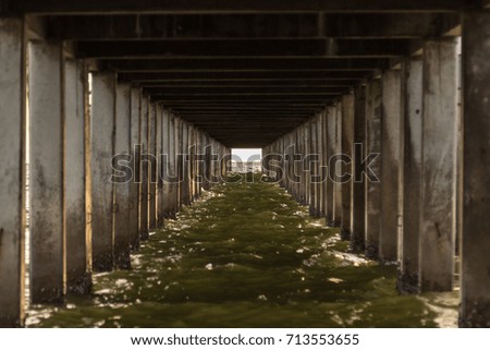 Selective focus, Under the old wooden bridge at beach and sea, clear water