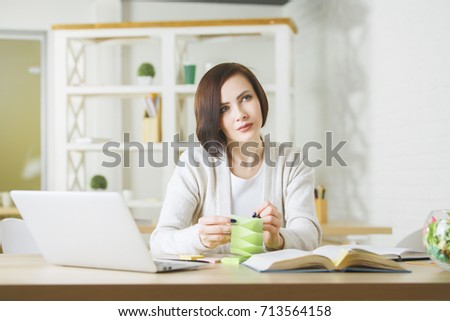 White business woman working on project at workplace. Female secretary using laptop and doing paperwork in modern office. Occupation concept 