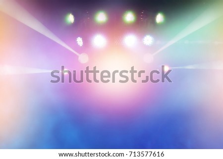 multi-colored light beams from the stage of the entertainment show. nightlife with music and entertainment, abstract background with defocused bokeh light.