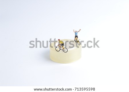 the mini figure ride bicycle isolated on Tape