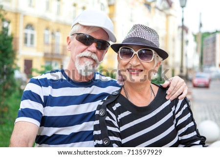 Happy mature man and woman leaned against each other. Mature man and woman smiling leaning against each other