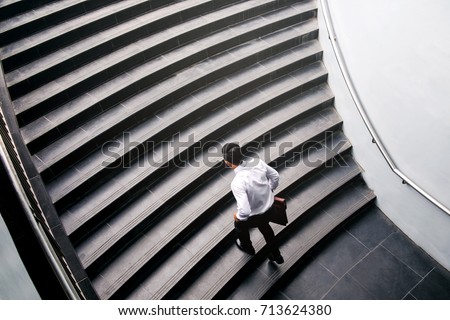 Businessman running fast upstairs Growth up Success concept Royalty-Free Stock Photo #713624380