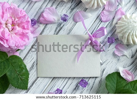 Peonies flowers with card marshmallow on a white wooden background - stock image.
