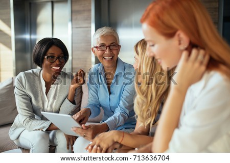 Happy business woman working together online on a tablet. Royalty-Free Stock Photo #713636704