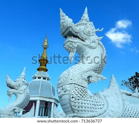 great white dragon statue protecting buddhist temple