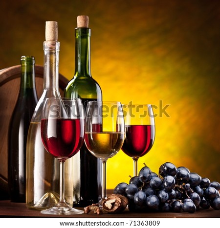 Still life with wine bottle, glass and oak barrels.