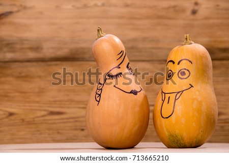 Happy pumpkin family funny faces isolated over rustic wooden background