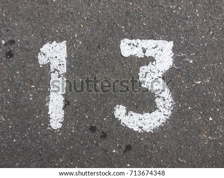 Number thirteen, painted on asphalt