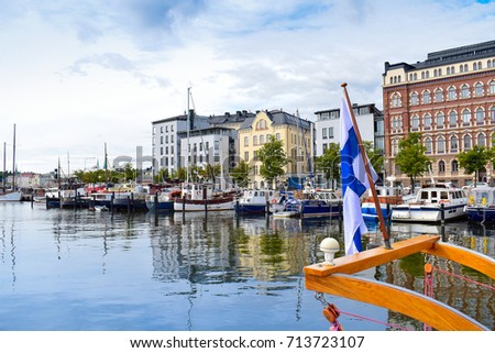 Finnish flag on the boat and summer view of North port Helsinki, Finland. Europe. Royalty-Free Stock Photo #713723107
