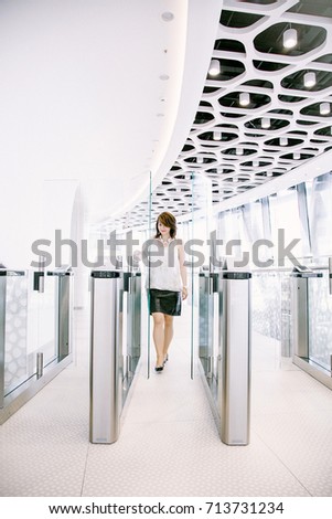 a business woman passes through an office pass