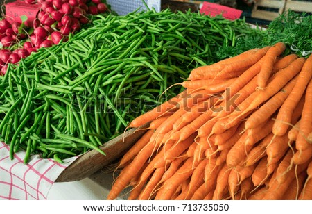 carrots and green beans on market display
