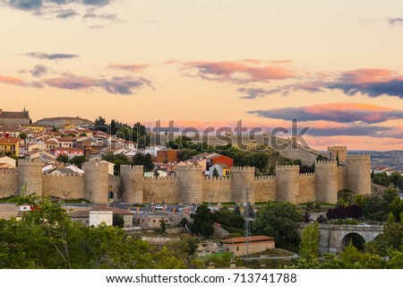 Famous medieval walls of the historic city of Avila in Spain at sunset, UNESCO World Heritage. Called the Town of Stones and Saints, its famous medieval town walls surround the city