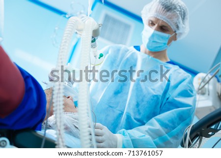 Attentive doctor helping his patient