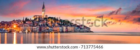 Fantastic spring sunset of Rovinj town, Croatian fishing port on the west coast of the Istrian peninsula. Colorful evening seascape of Adriatic Sea. Traveling concept background.