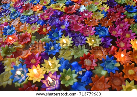 Colorful flower candles for floating point to worship the Buddha in Thailand.