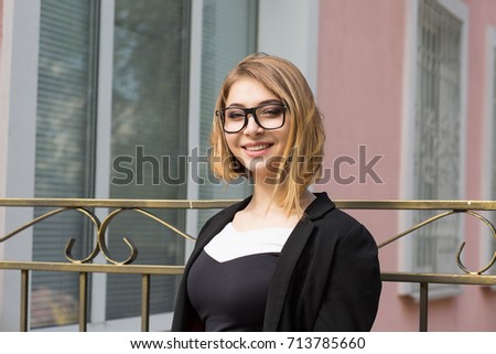 Woman outdoors. Half length body woman girl looking at you camera smile on face, black suit formal wear, eye glasses outside city urban home, house office on background