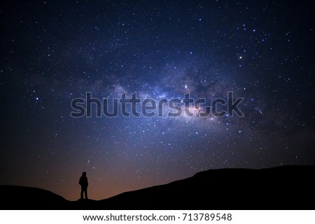Landscape with milky way, Night sky with stars and silhouette of man standing on high moutain Royalty-Free Stock Photo #713789548