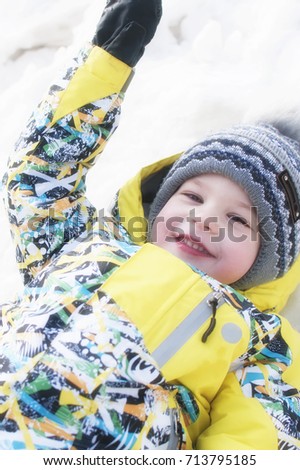 Little boy playing in the snow, portrait