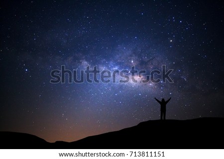 Landscape with milky way, Night sky with stars and silhouette of man standing on high moutain