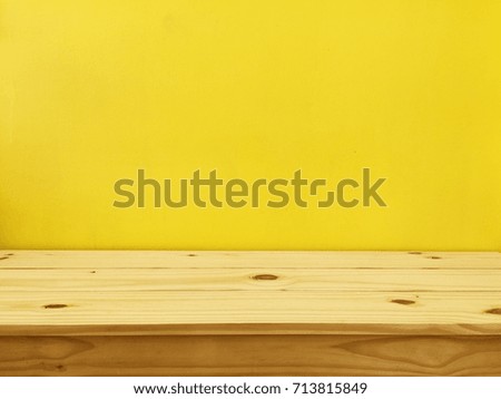 Yellow wall with wood table