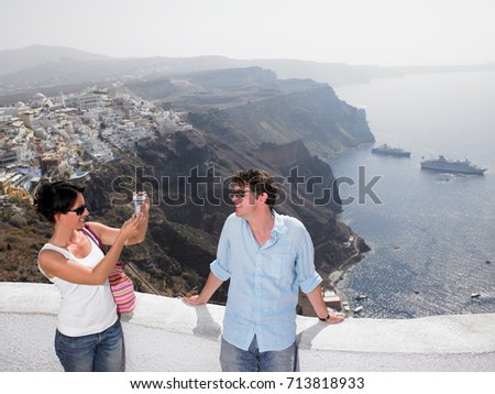 Woman taking pictures of her man