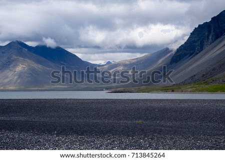 Typical mountain landscape with river and dramatic sky in Iceland. 