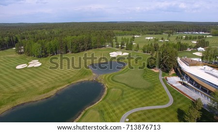 Solar Golf cart with clouds on blue sky and forest lake Golf club, aerial