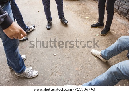 Legs of a group of people standing around