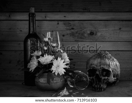 Still life with human skull with wine and  flower in vintage vase