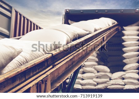White sugar bags stuffing into a container for export, vintage color. Royalty-Free Stock Photo #713919139