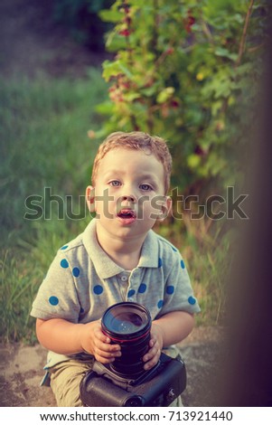 Little boy with camera in the park