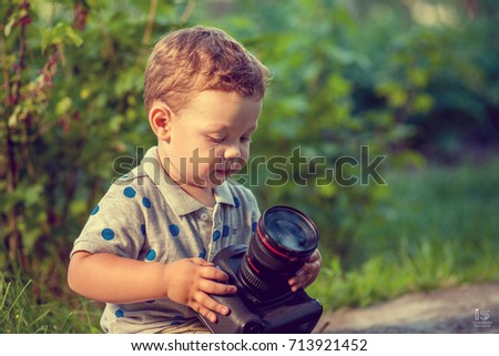 Little boy with camera in the park