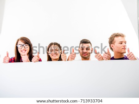 Group of people with a blank sign