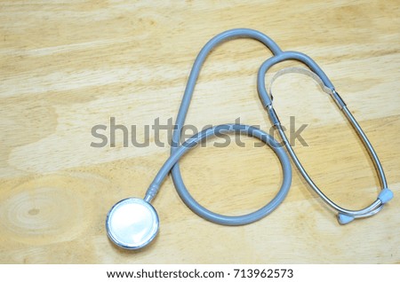 Stethoscope on wooden background.