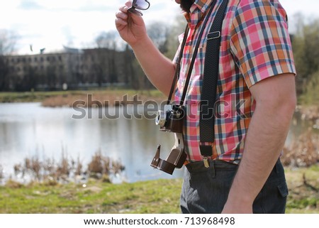 beard man with retro camera in the park 
