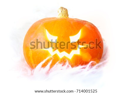 Glowing eyes in a pumpkin on Halloween isolated, white background