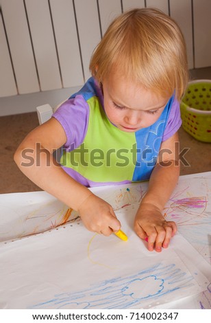 baby painted with colored crayons