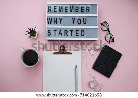 Work space with Modern Board with text Remember why you started, coffee, plant, phone, sheet, pencils, candy on a pink background. Top view, flat lay, space for text Royalty-Free Stock Photo #714021658