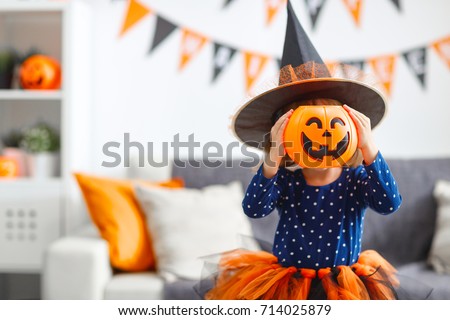 happy laughing child girl in witch costume to halloween Royalty-Free Stock Photo #714025879