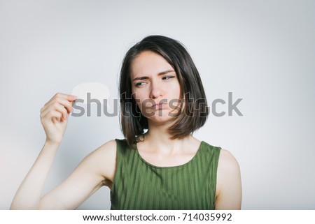 beautiful young woman showing a thought sticker, isolated studio photo