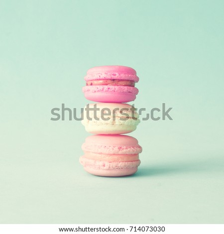 Three french macaroons over mint background