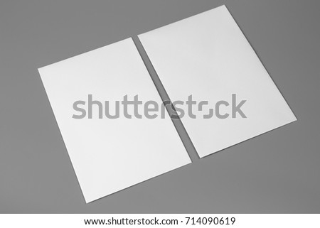 Blank portrait A4. brochure magazine isolated on gray, changeable background / white paper isolated on gray Royalty-Free Stock Photo #714090619