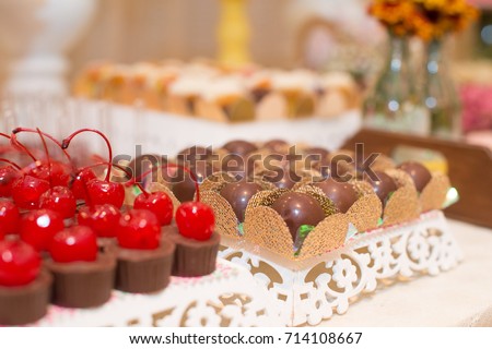 Macro picture of truffles and chocolates with cherry for woman party