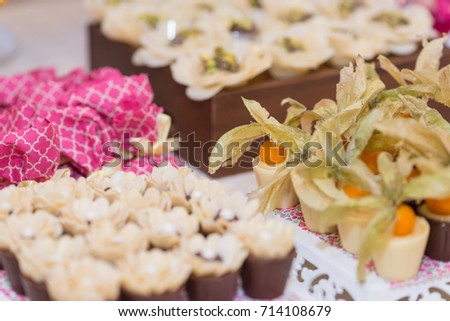 Horizontal picture of ornated table with bonbon with fruits and white chocolate for woman party