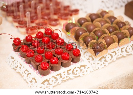 Horizontal picture of delicious dessert made  with chocolates with cherry and truffles for woman party