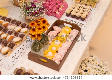 Horizontal picture of ornated table with black and white Brigadeiro, traditional Brazilian delicacy made of condensed milk cocoa with chocolate